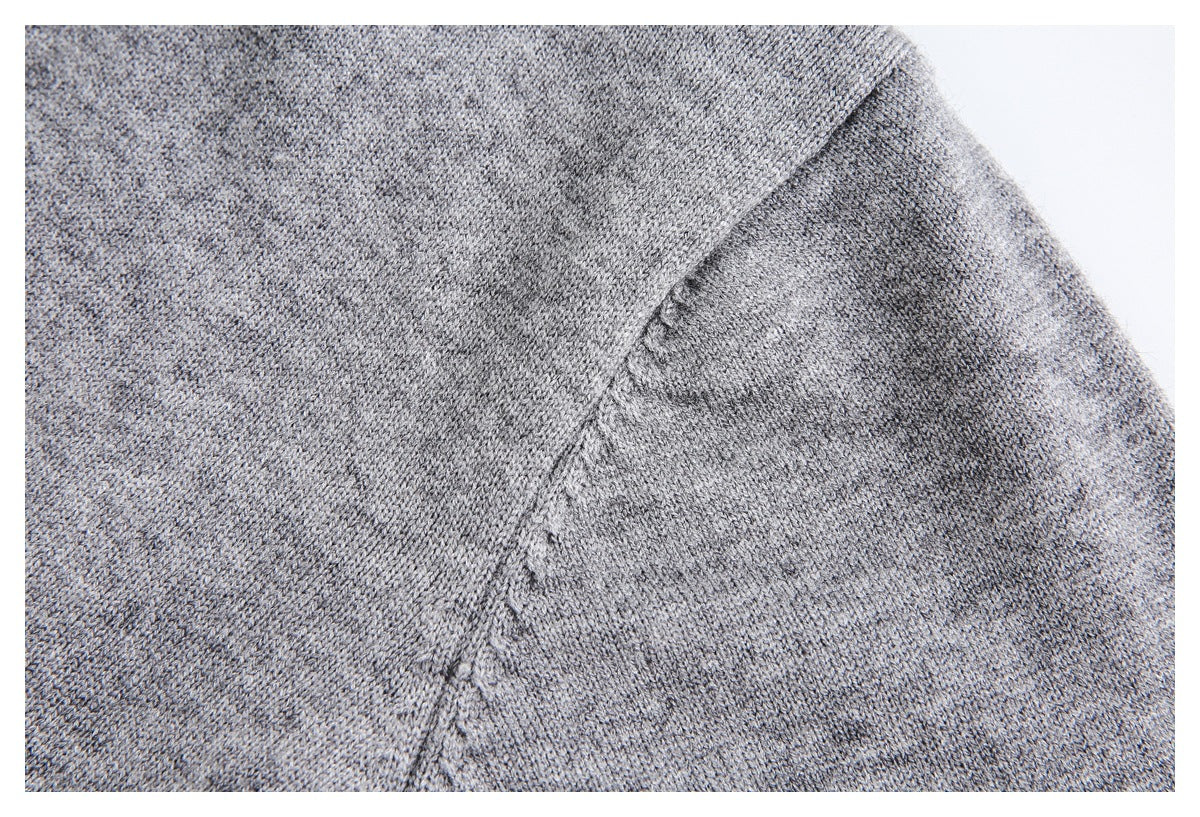 Close-up of heather gray knit fabric and a diagonal garment seam.