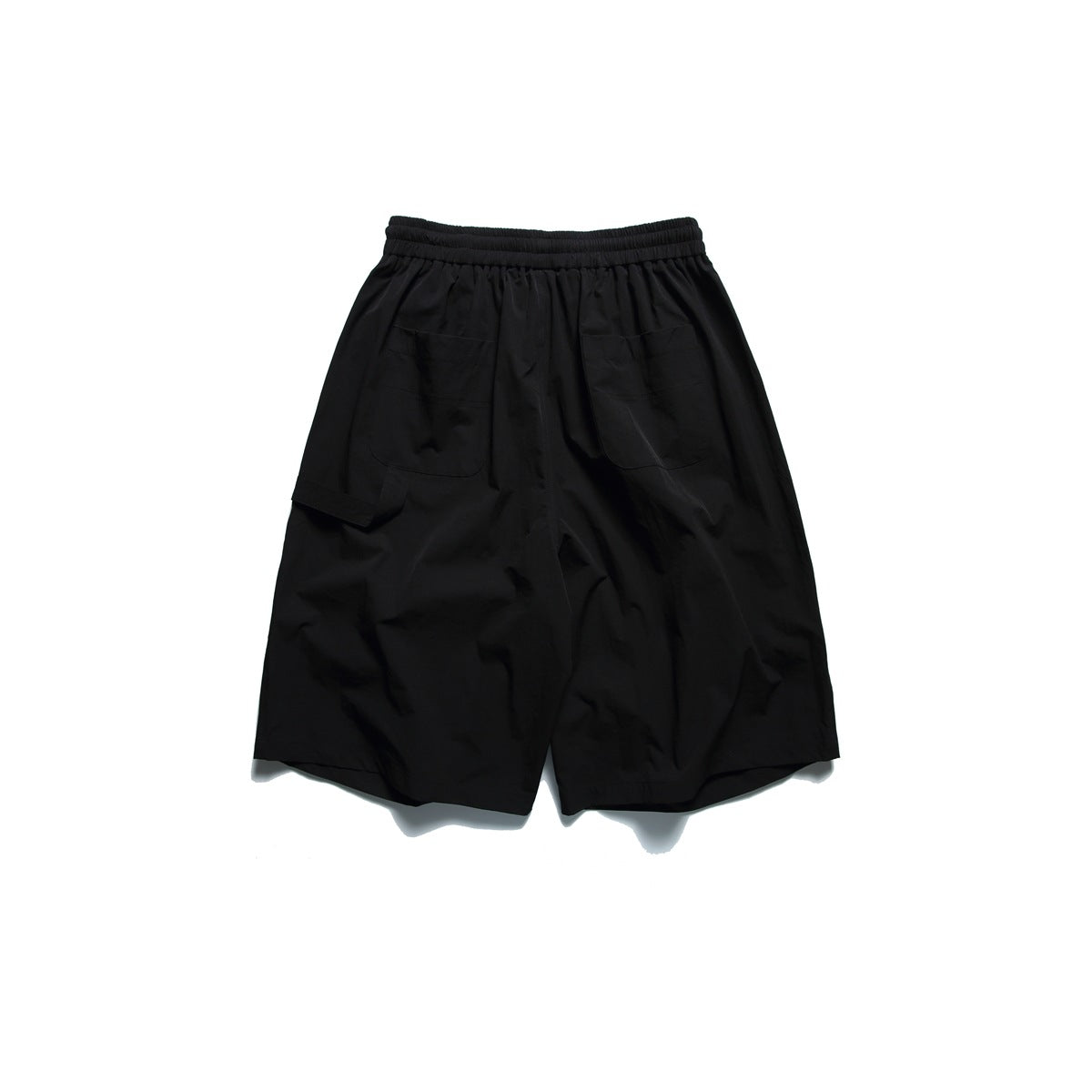 Black shorts back view with two patch pockets, elastic waistband and a side flap pocket, flat lay