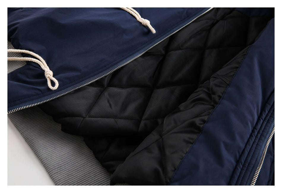 Open navy jacket showing black quilted lining, a front zipper and gray ribbed trim.