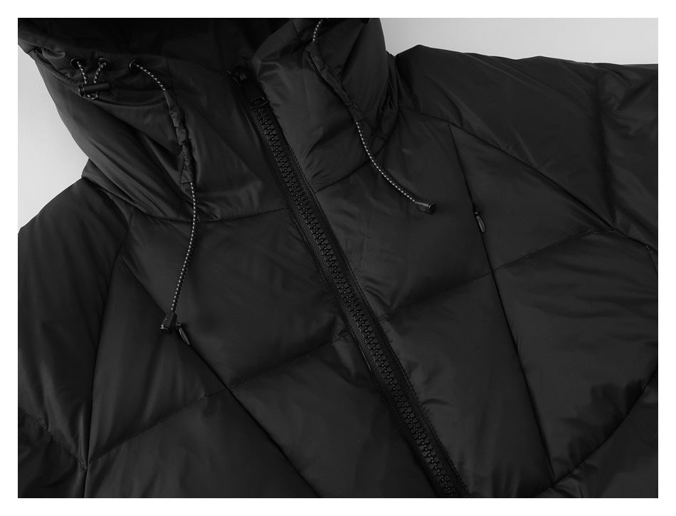 Close-up of a black quilted jacket with a hood, drawcords, and front zipper.