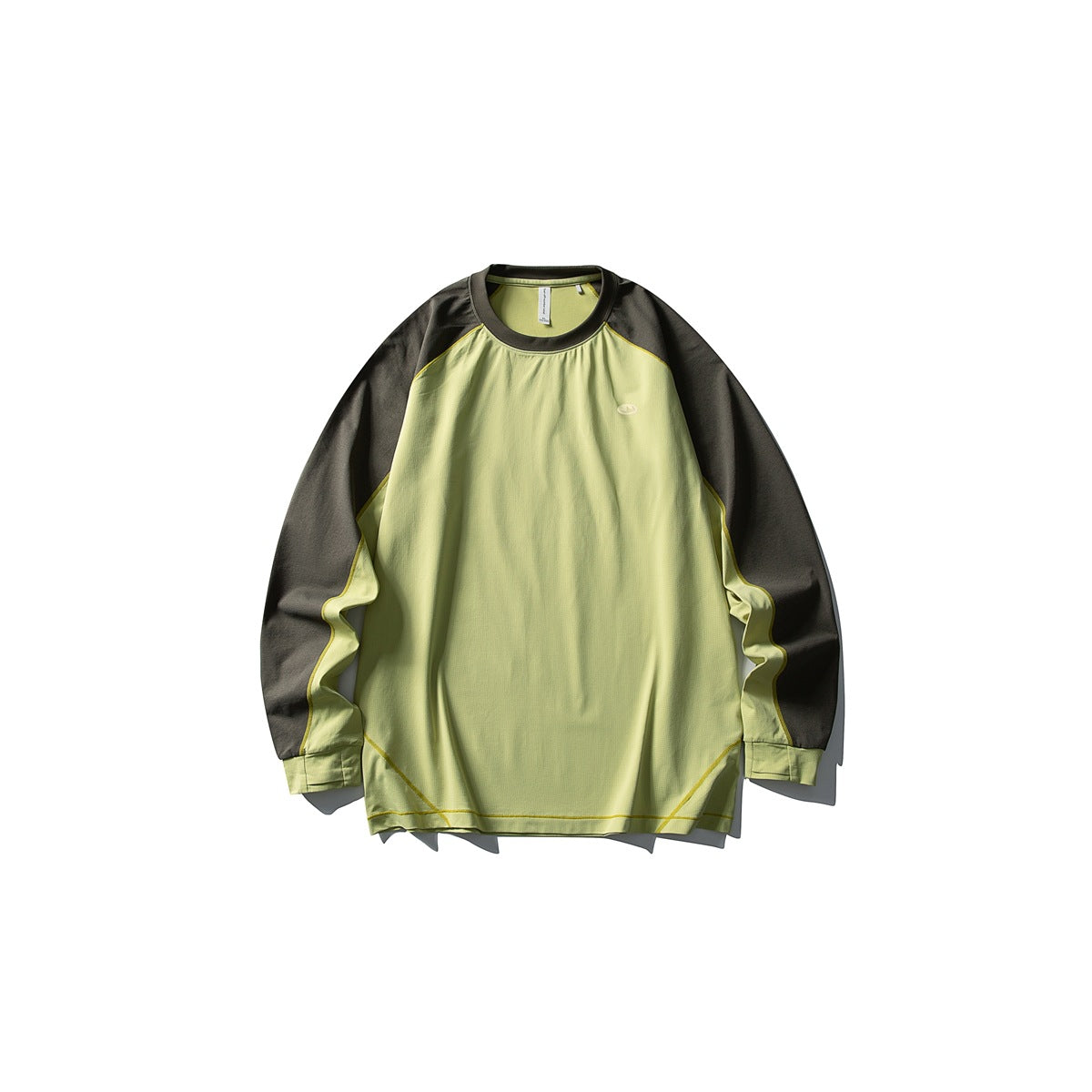 Front view of a lime-green long-sleeve crewneck top with charcoal sleeves and yellow seam piping, laid flat on white.