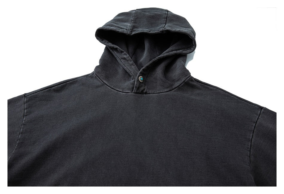 Front close-up of a charcoal hooded pullover with a turquoise neckline button and a plain body.