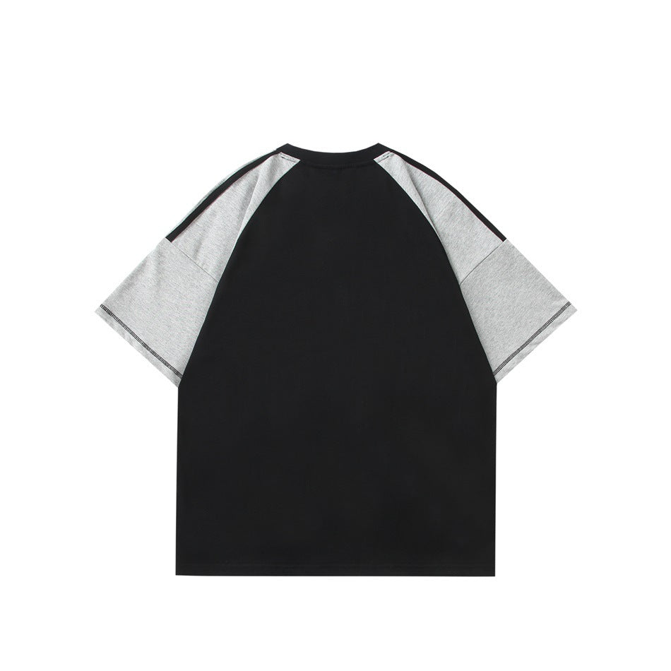 Back view of a black T-shirt with heather gray raglan sleeves and dark contrast topstitching on the sleeve hems