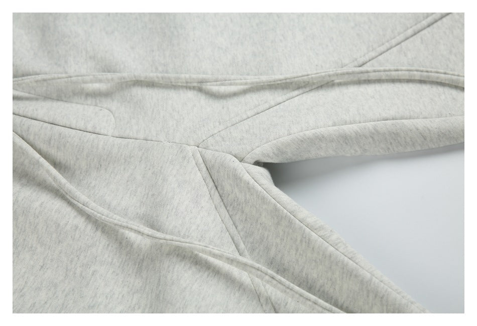 Close-up of the seams and leg construction on light gray marl sweatpants.