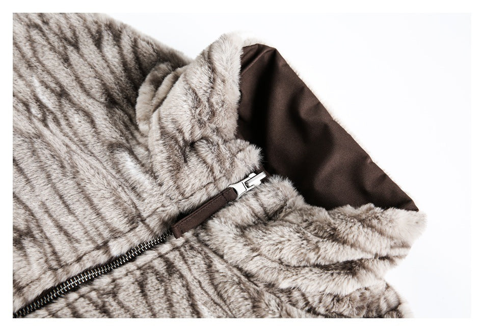 Close-up of a gray patterned plush jacket collar, brown lining, and front zipper.
