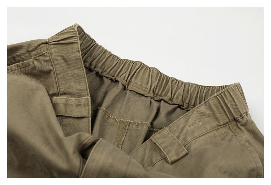 Close-up of the trousers’ interior elastic waistband, belt loops, and stitching in olive khaki.