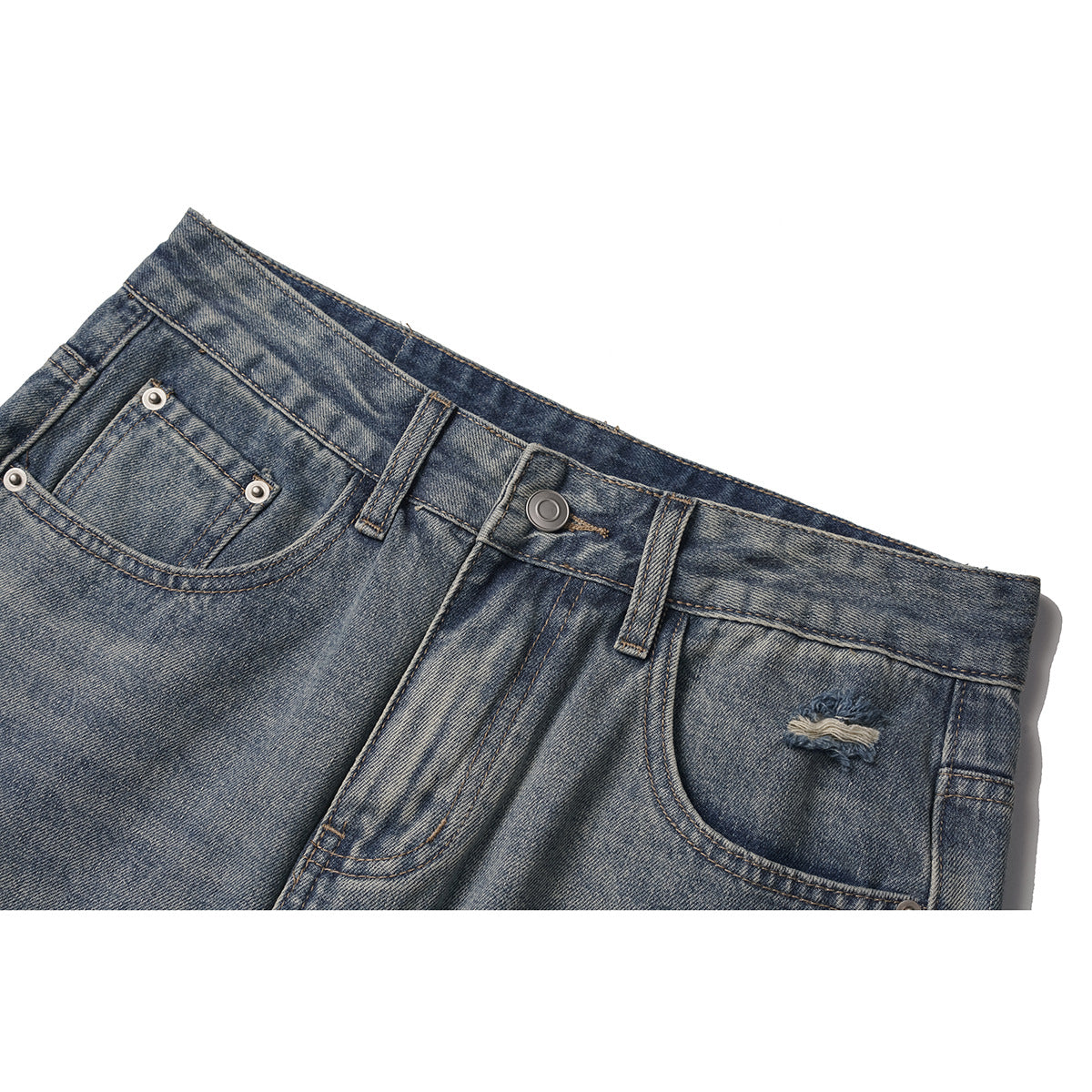 Close-up of faded blue jeans showing the waistband, button, front pockets, belt loops, and a small distressed patch.