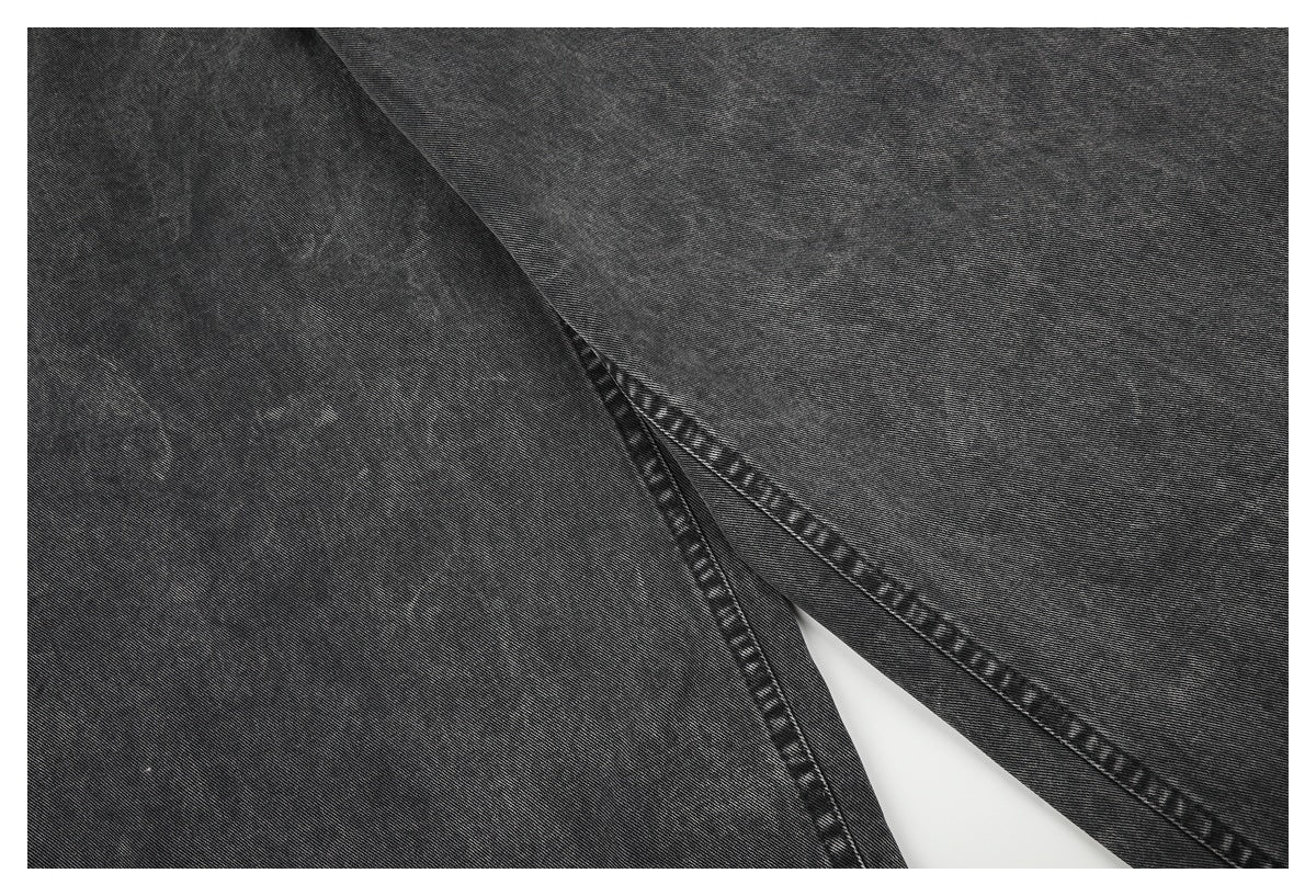 Close-up of the charcoal-gray jeans' leg seams and stitching near the inner leg.