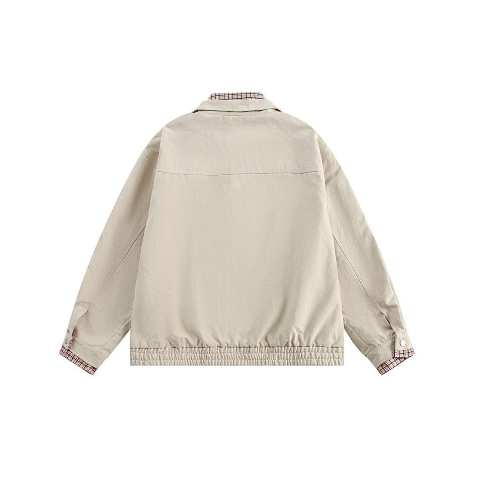 Back view of a light beige jacket with a gathered hem and pink checked fabric showing at the collar and cuffs.