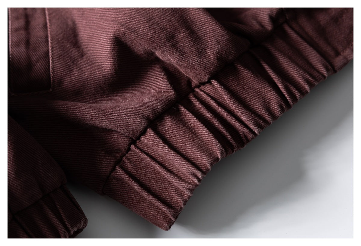 Close-up of gathered elastic fabric at the burgundy garment's edge.