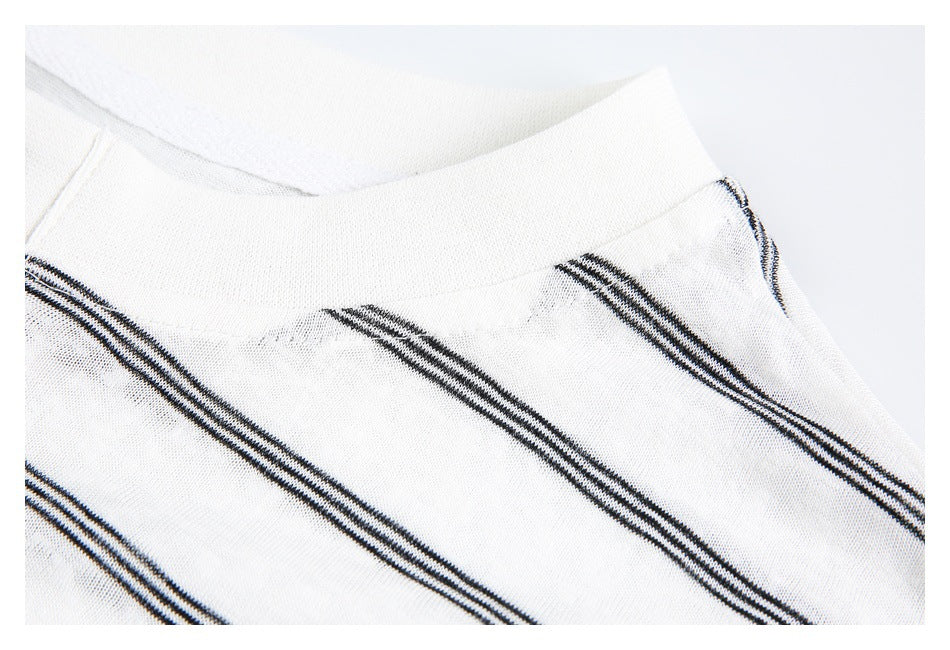Close-up of a white neckline and striped knit fabric.