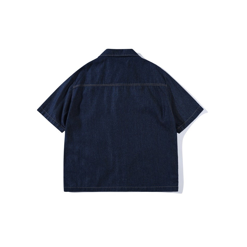 Back view of dark indigo short-sleeve denim shirt showing yoke seam and contrast topstitching
