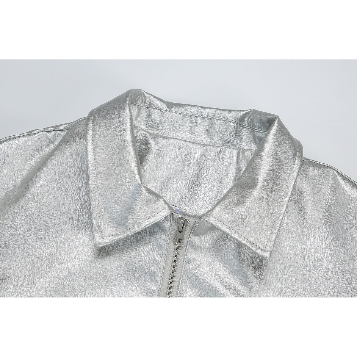 Close-up of a silver jacket collar and front zipper.