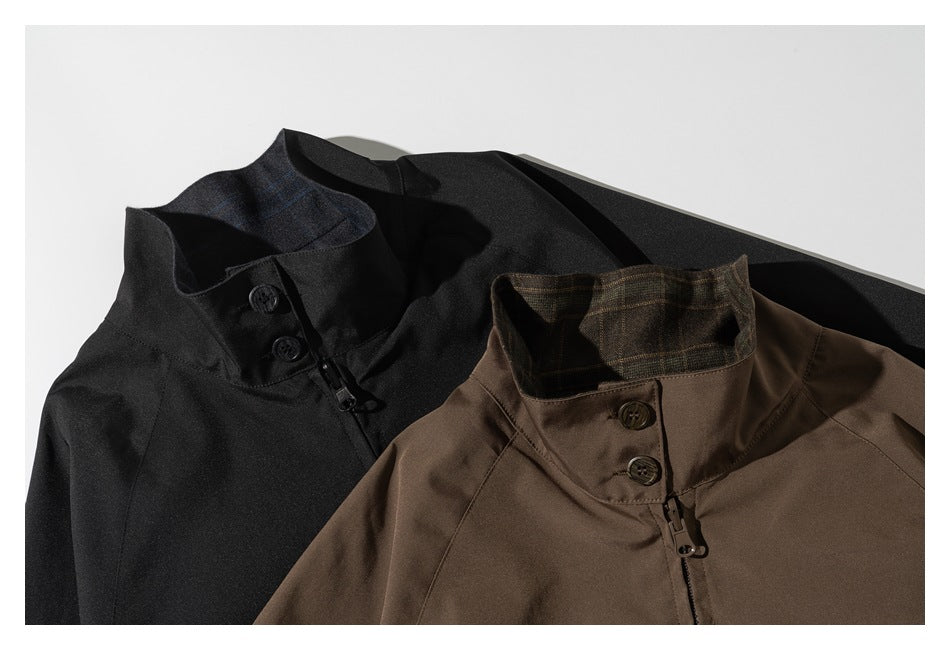 Close-up of black and brown jackets showing stand collars, buttons, and front zippers.