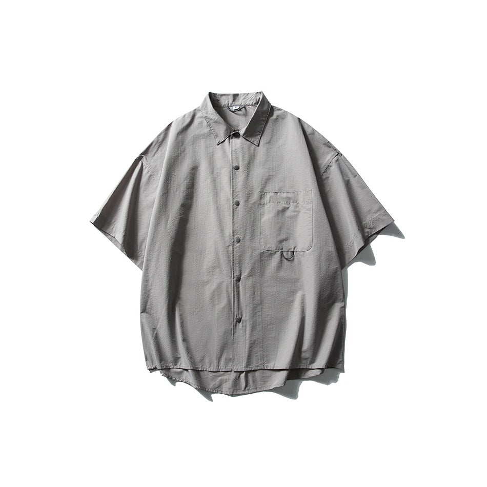 Gray short-sleeve button-front shirt with collar and chest pocket, flat lay on white background