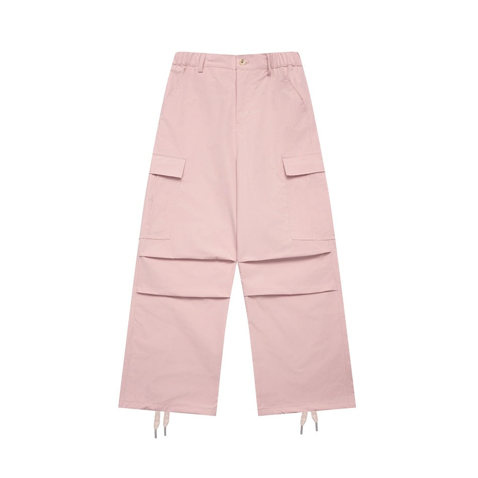 Pink wide-leg cargo pants flat lay with elastic waist, flap pockets, knee pleats and drawstring hems