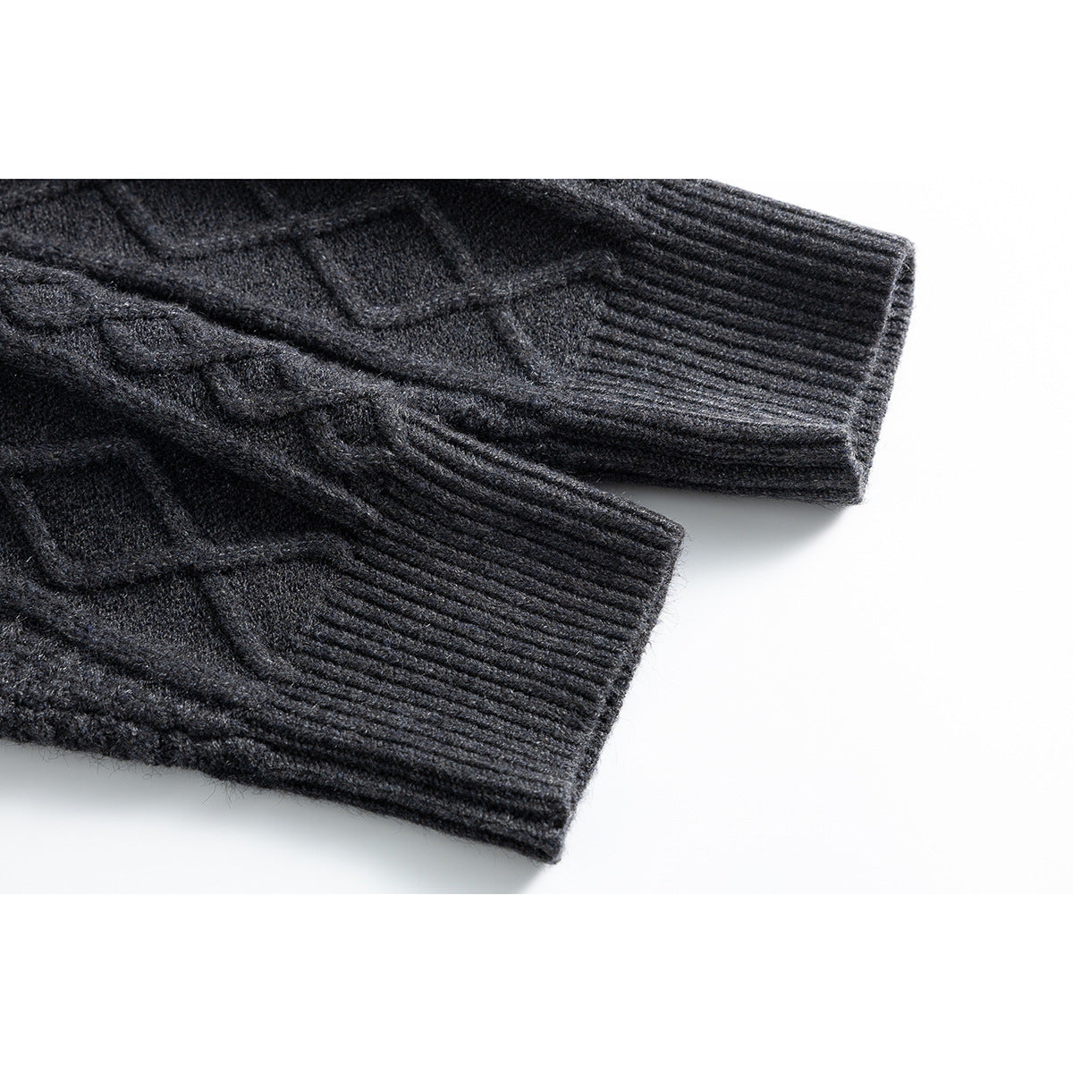 Close-up of the charcoal cardigan's cable-knit sleeves and wide ribbed cuffs.