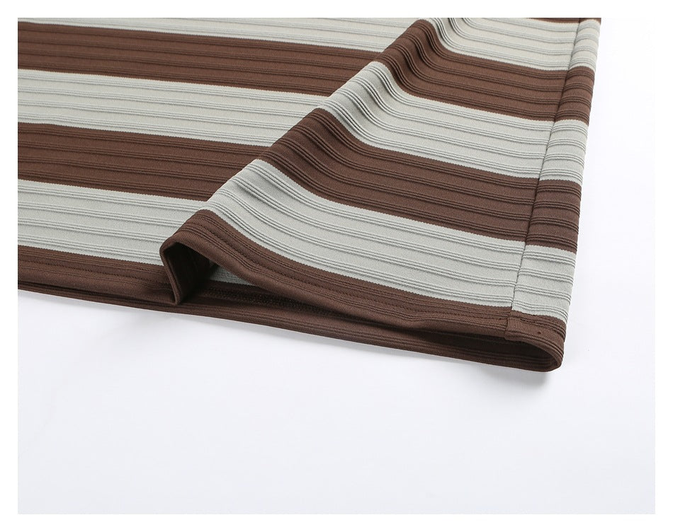 Close-up of the striped shirt’s folded bottom hem and side seam.