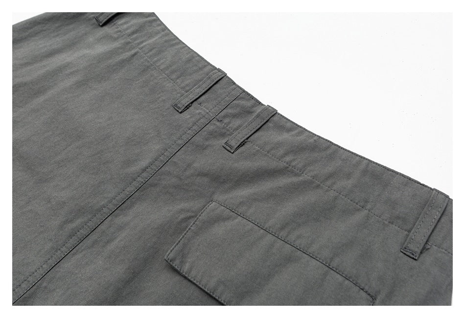 Close-up of the back of charcoal-gray trousers, with belt loops and a rectangular patch pocket.