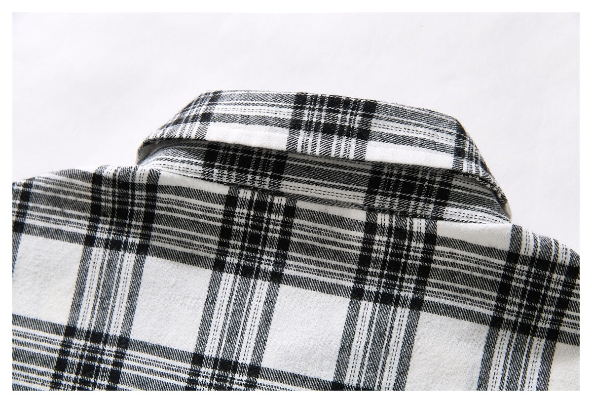 Close-up of the back yoke and collar of a black-and-white plaid shirt.