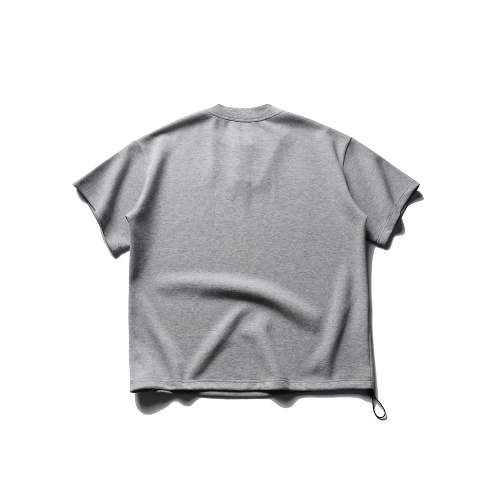 Back view of a heather-gray short-sleeve shirt laid flat, with a black loop at the lower hem.