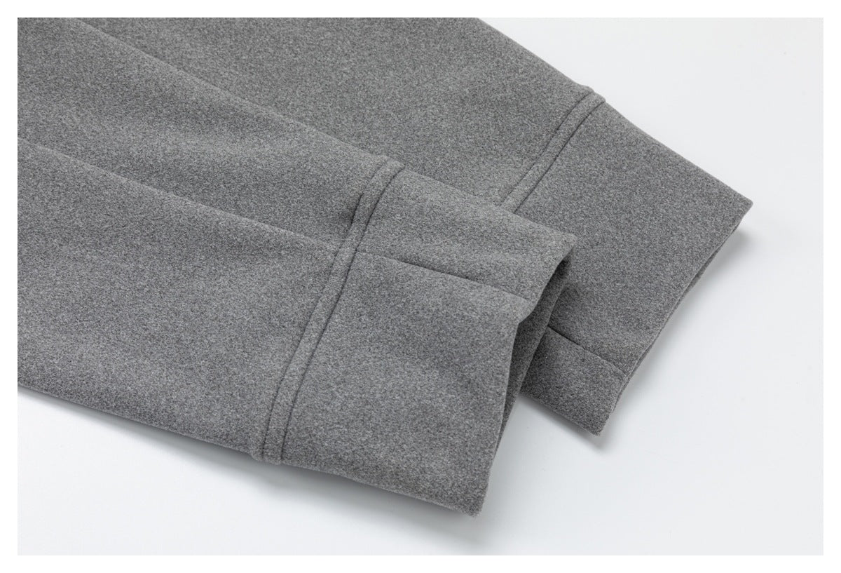 Close-up of a gray garment cuff or hem with a visible stitched seam.