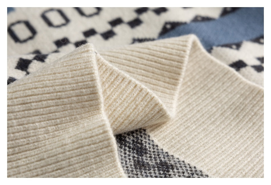 Close-up of the sweater's thick ivory rib-knit collar against its patterned body.