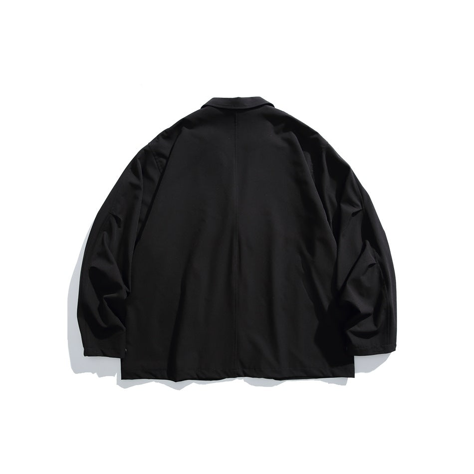 Back view of a black blazer laid flat, showing its collar, long sleeves, and center back seam.