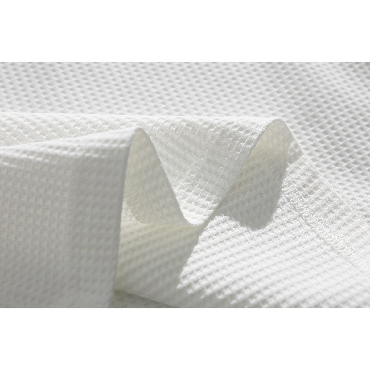 Close-up showing the raised texture and stitching of white polo fabric.
