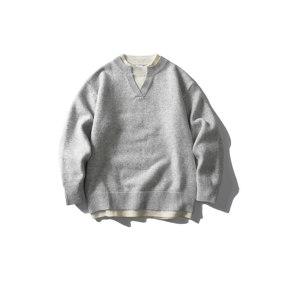 Light gray knit pullover sweater with notched V-neck and cream layered trim, flat lay front view