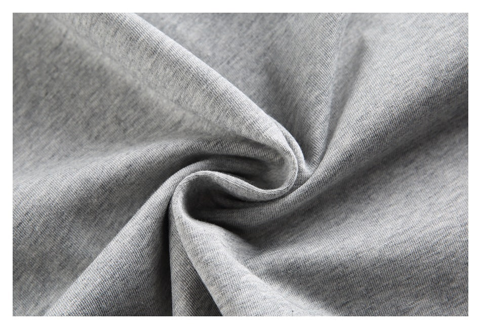 Close-up of heather gray knit fabric gathered into soft folds.