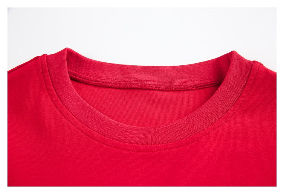 Close-up of the ribbed crew neckline and stitching on a red T-shirt.