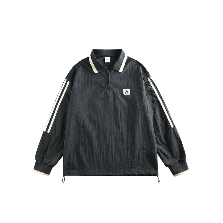 Dark green quarter-zip polo-collar jacket with cream collar, cuff and sleeve stripes, chest patch and hem drawcords