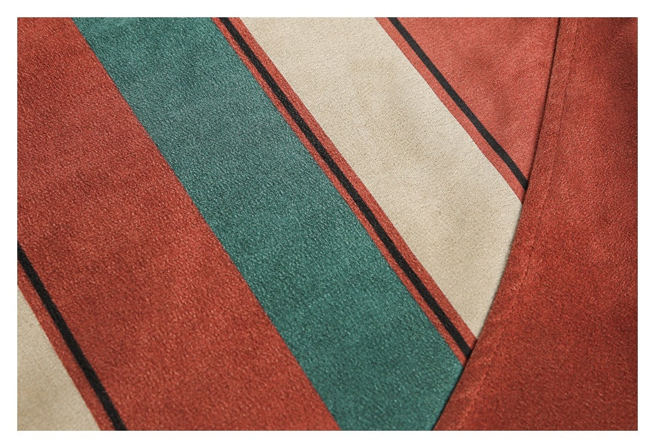 Close-up of rust-red, teal, cream, and black striped fabric with a textured surface.