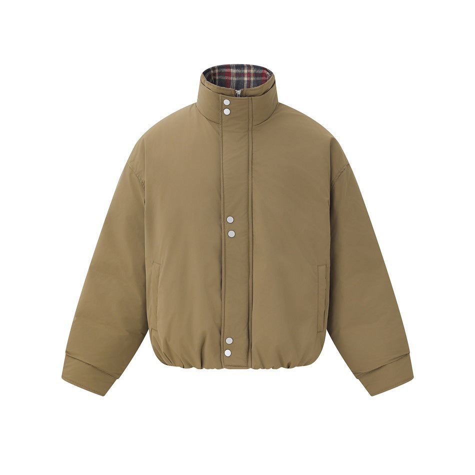 Khaki puffer jacket flat lay, front view, with stand collar, snap-and-zip placket, side pockets and plaid collar interior
