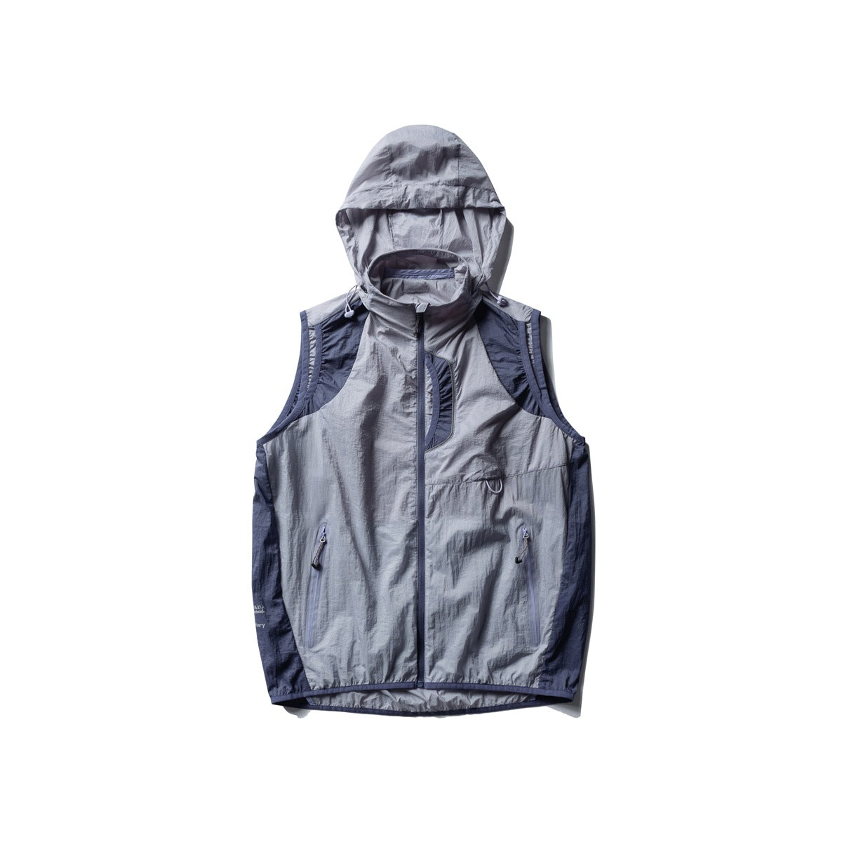 Light blue-gray hooded zip vest flat lay with navy side panels, zippered pockets and drawstring hood toggles