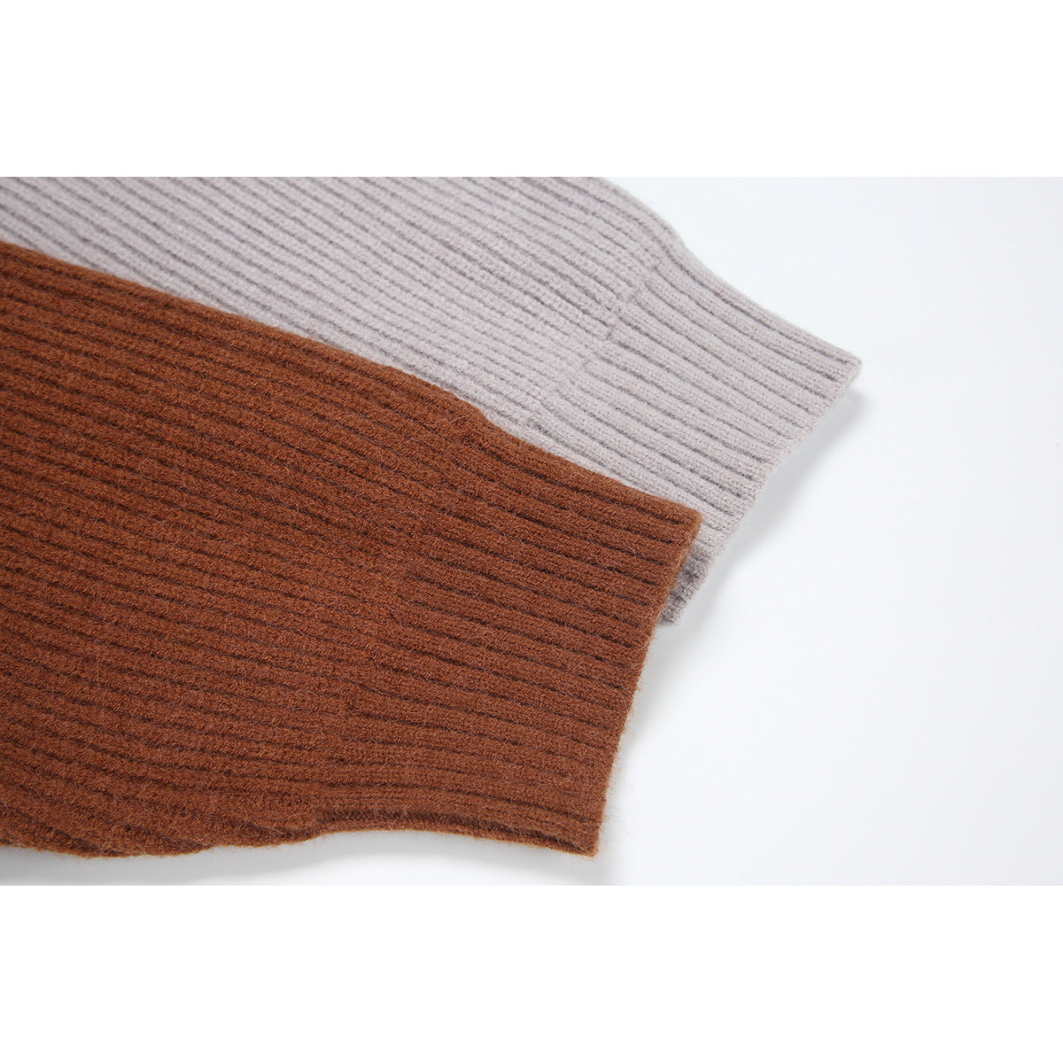 Close-up of rust-brown and light gray ribbed cardigan sleeve cuffs side by side.