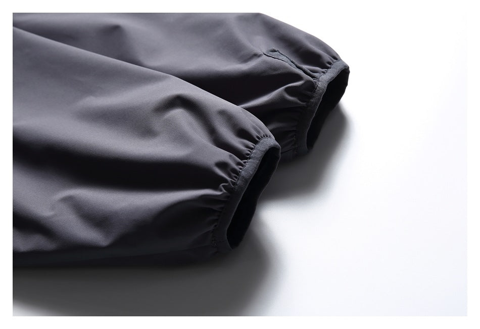 Close-up of the jacket's charcoal-gray sleeves with gathered elastic cuffs.