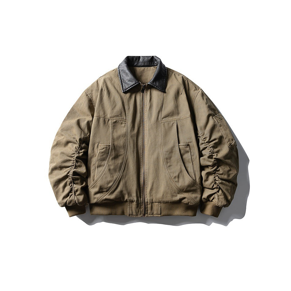 Khaki padded bomber jacket with dark leather-look collar, front zipper, curved seams and ruched sleeves, flat lay