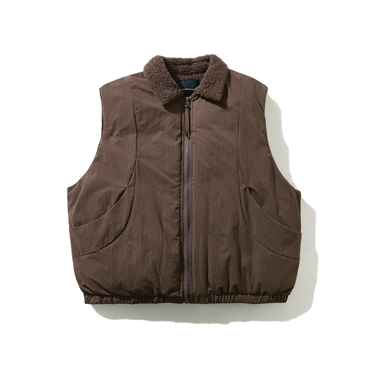 Brown sleeveless zip vest with fleece-like collar, curved pockets and elastic hem, flat front view