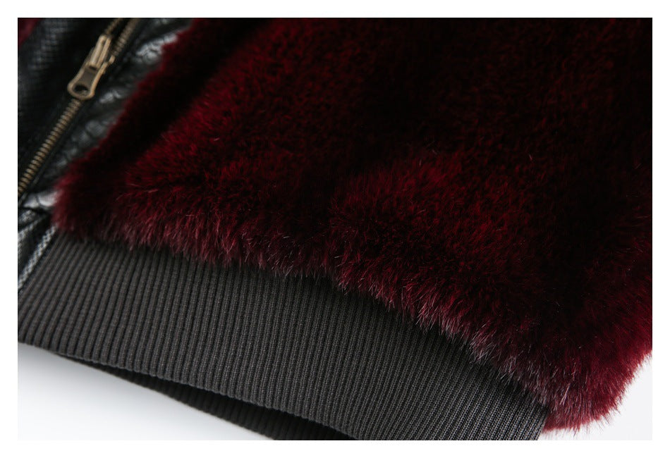 Close-up of burgundy pile meeting a ribbed black edge, with part of a metal zipper visible.