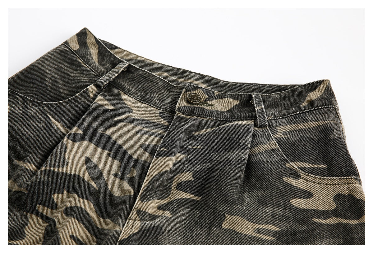 Close-up of the front waistband, button, belt loops, and pocket on camouflage shorts.