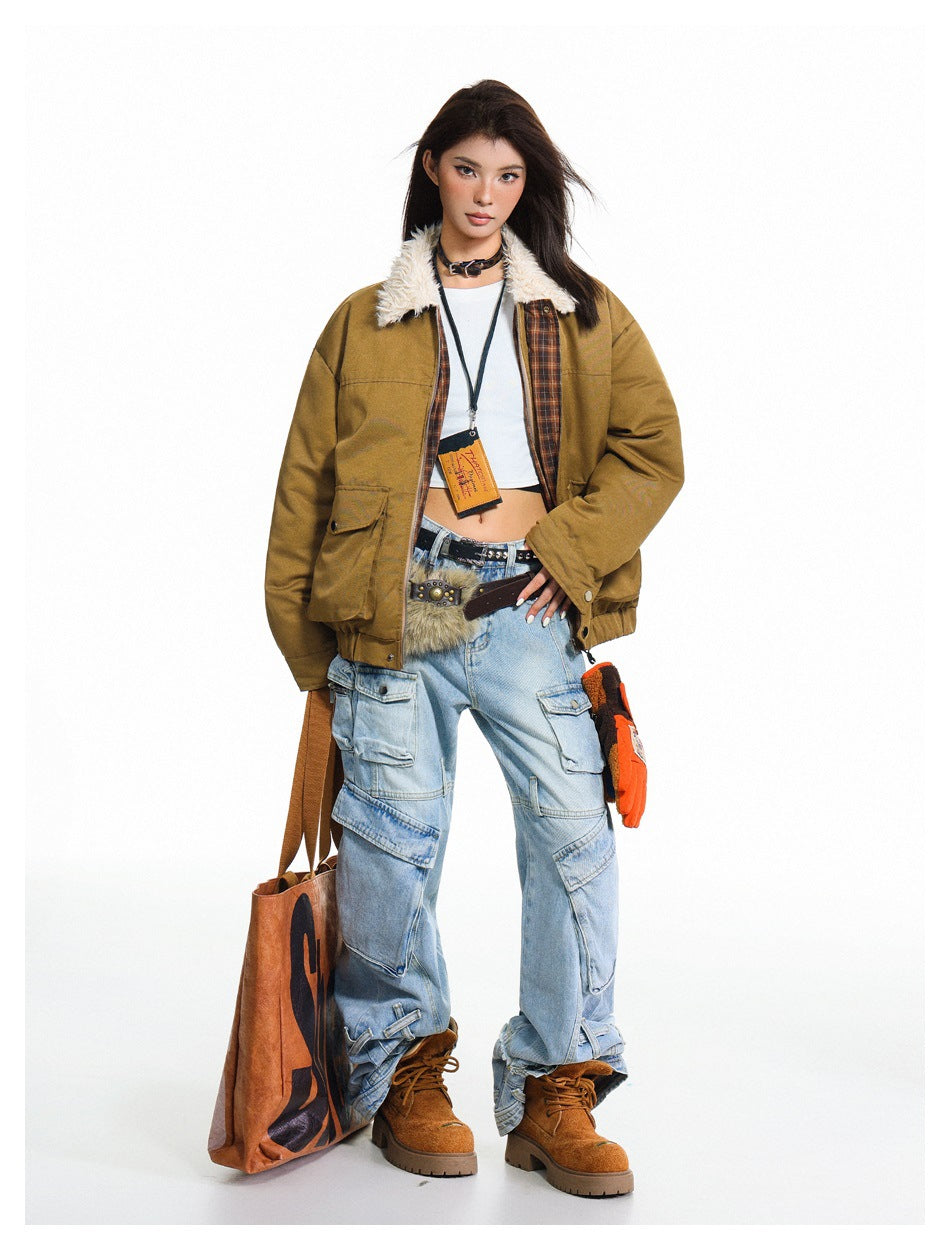 Full-length view of a model in a tan collared jacket with plaid inner facing, white top, cargo jeans and brown boots
