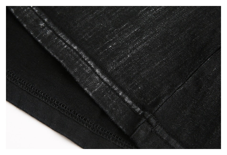 Close-up of black garment fabric and stitched hem seams.