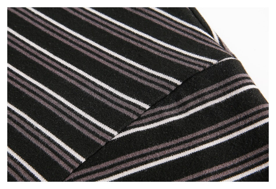 Close-up of the striped black fabric and a diagonal shoulder seam.