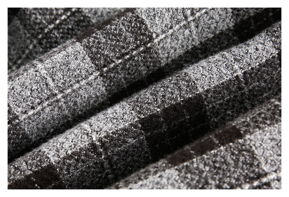 Macro view of the fuzzy black, gray, and white plaid garment texture.