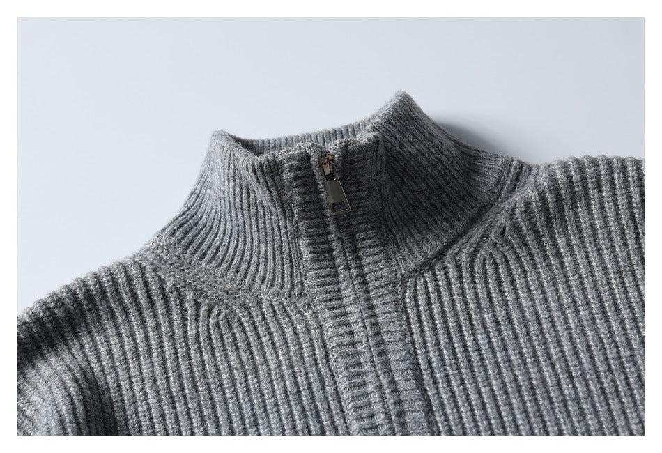 Close-up of a gray rib-knit zip sweater's high collar, shoulder seams and zipper.