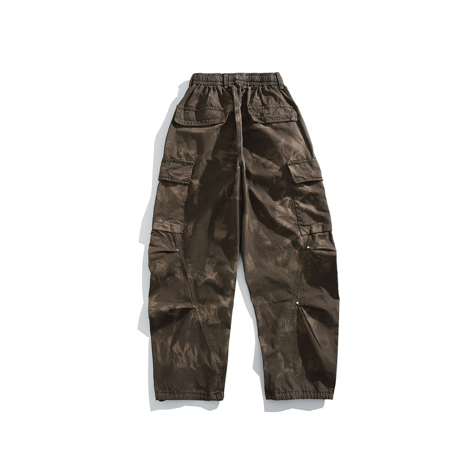 Back view of coffee brown tie-dye wash cargo pants with elastic waist, flap pockets and rivet-accented side seams