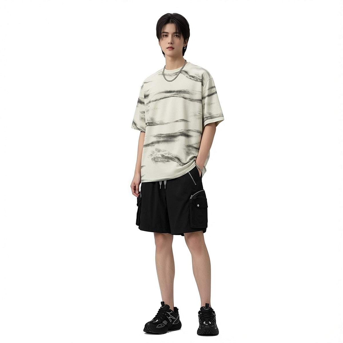 Model wearing an oversized ivory T-shirt with charcoal wavy stripes and black cargo shorts.