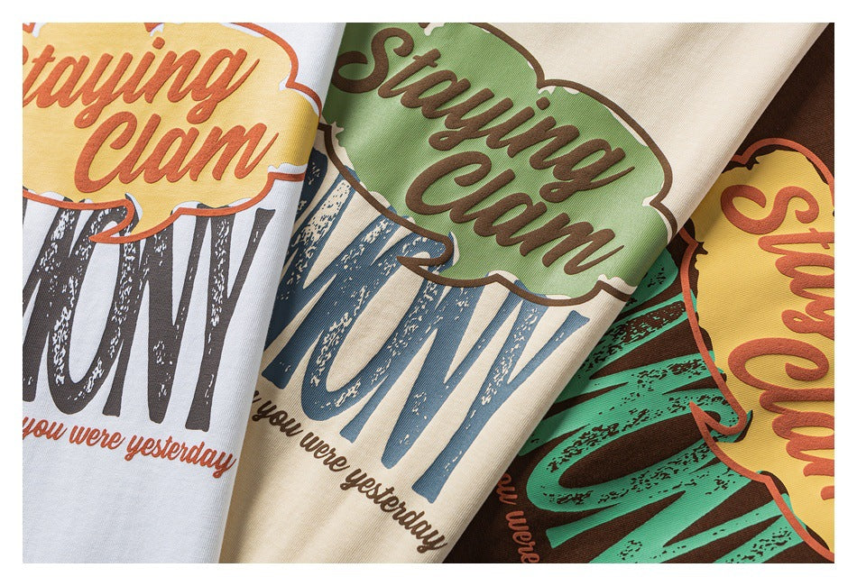 Close-up of several T-shirt colorways with the same colorful “Staying Calm” graphic.